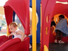 Toddler sliding in playground