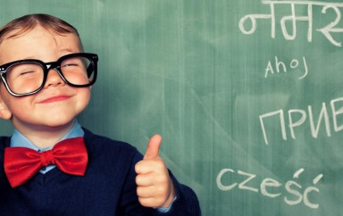 Multilingual child standing in front of blackboard