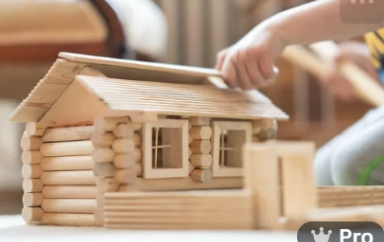 a kid putting together a toy house