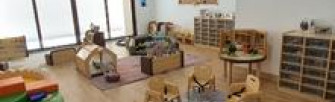 Nursery classroom with chairs toys and floor mats