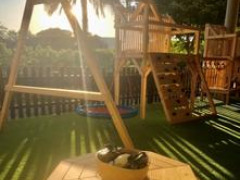 Outdoor playground with timber swings and table